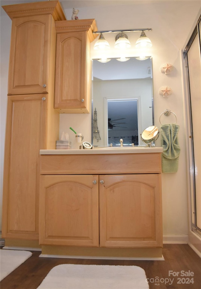 bathroom featuring an enclosed shower, hardwood / wood-style flooring, and vanity