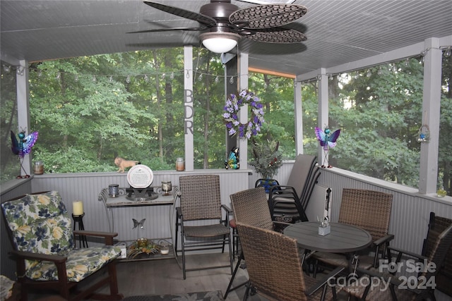 sunroom / solarium featuring ceiling fan