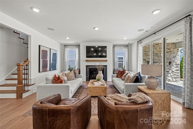 living room featuring light hardwood / wood-style flooring and a healthy amount of sunlight