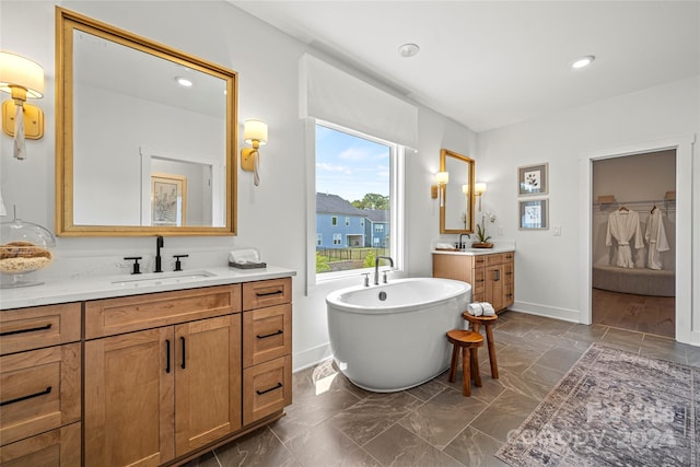 bathroom with vanity and a tub