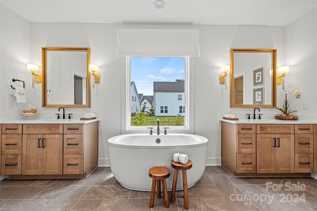 bathroom featuring a tub to relax in and vanity