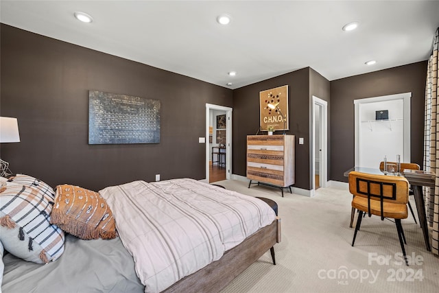 bedroom featuring light carpet and a closet