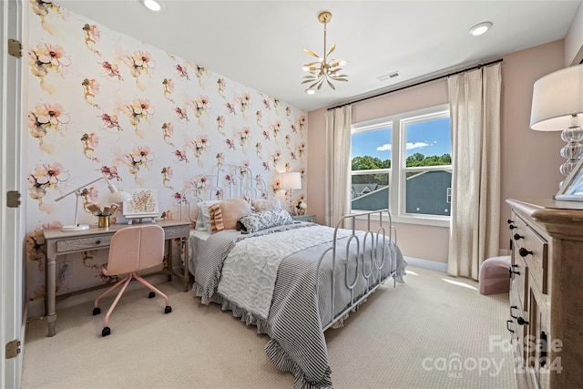 carpeted bedroom with an inviting chandelier