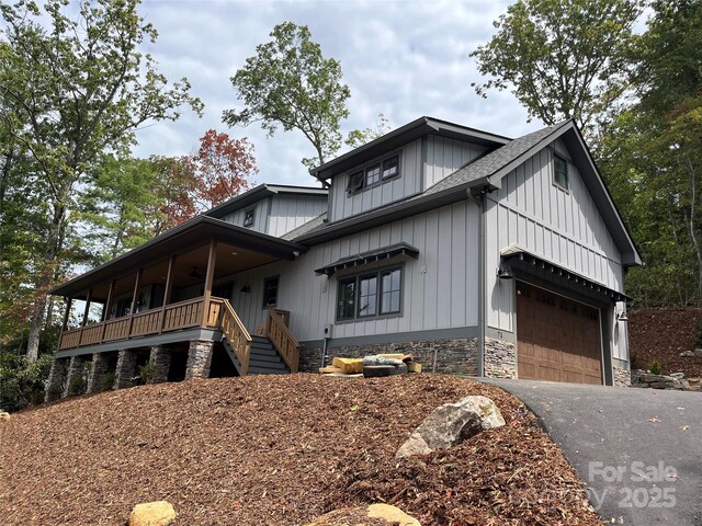 71 Crossings Cir, Fairview, NC 28730 - modern inspired farmhouse featuring a garage, driveway, a porch, a shingled roof, and board and batten siding
