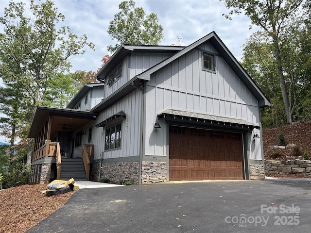 71 Crossings Cir, Fairview, NC 28730 - view of front facade with asphalt driveway, board and batten siding, a garage, and stairs