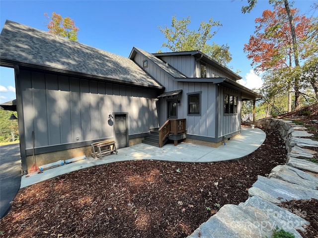 71 Crossings Cir, Fairview, NC 28730 - rear view of property with board and batten siding, a patio area, and roof with shingles