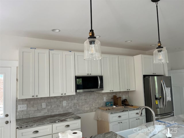 71 Crossings Cir, Fairview, NC 28730 - kitchen with appliances with stainless steel finishes, light stone countertops, and white cabinets
