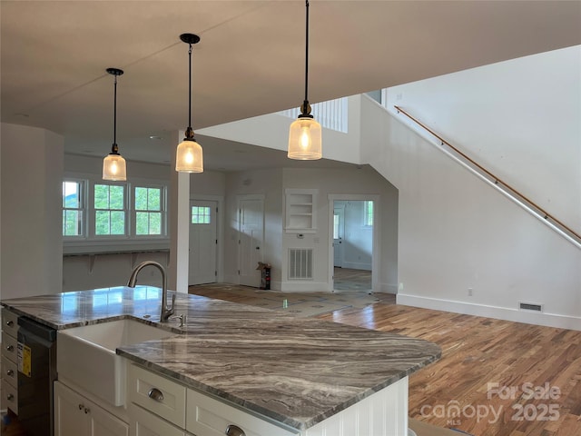 71 Crossings Cir, Fairview, NC 28730 - kitchen with dishwasher, open floor plan, white cabinets, light wood finished floors, and hanging light fixtures
