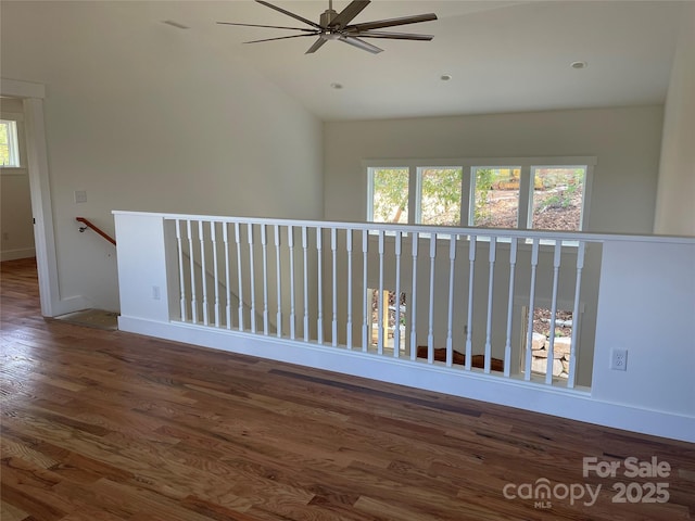 hall with dark hardwood / wood-style floors and lofted ceiling