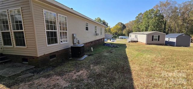 view of yard with a shed and central AC unit