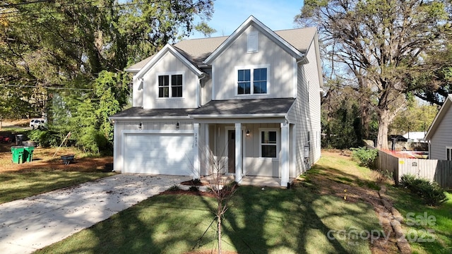 view of front of home featuring a front yard and a garage