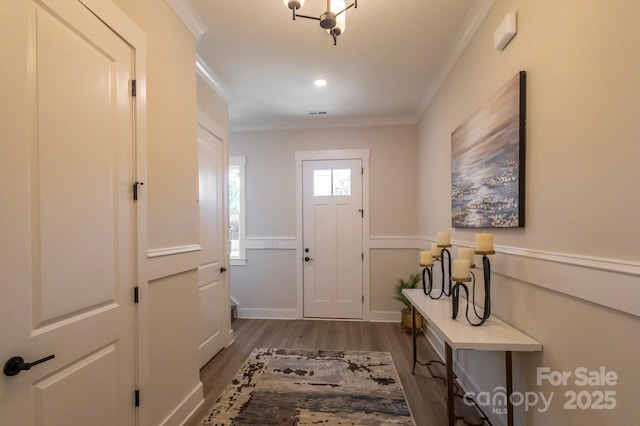 doorway featuring dark wood-type flooring and ornamental molding