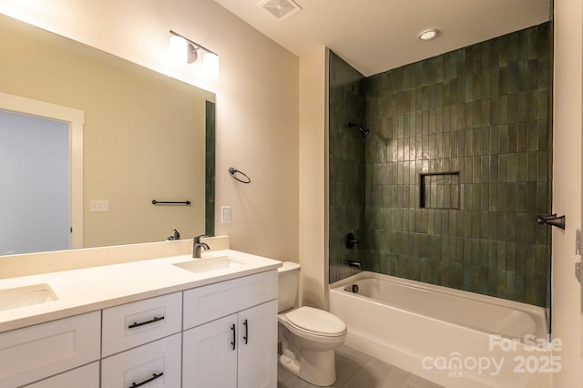 full bathroom with tile patterned flooring, vanity, toilet, and tiled shower / bath