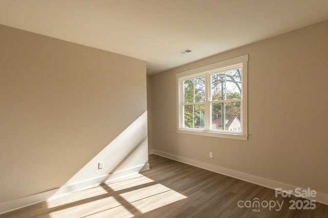 empty room with hardwood / wood-style flooring