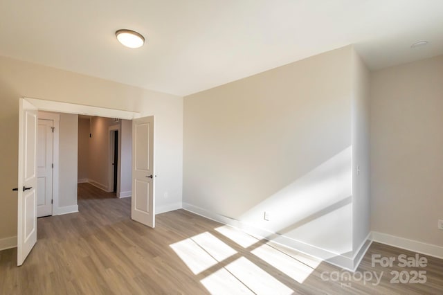 unfurnished room with light hardwood / wood-style flooring