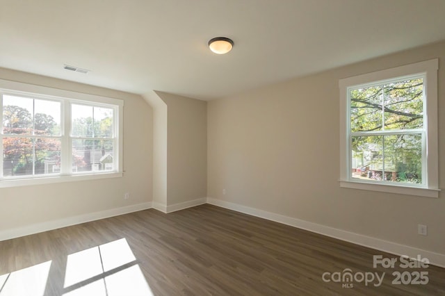 spare room with dark hardwood / wood-style flooring