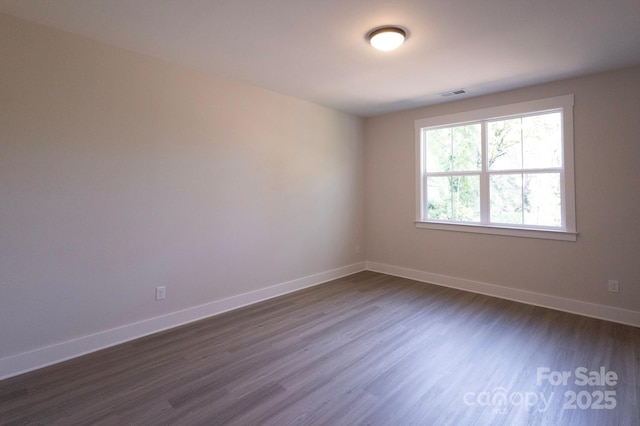 empty room featuring dark wood-type flooring