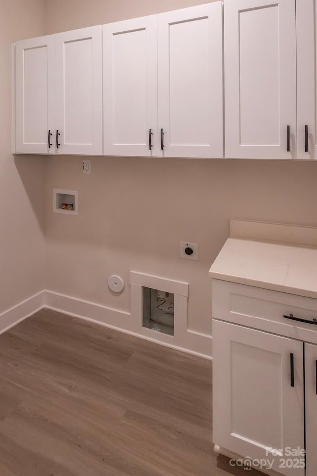 laundry area with cabinets, hookup for a gas dryer, hookup for a washing machine, hookup for an electric dryer, and wood-type flooring