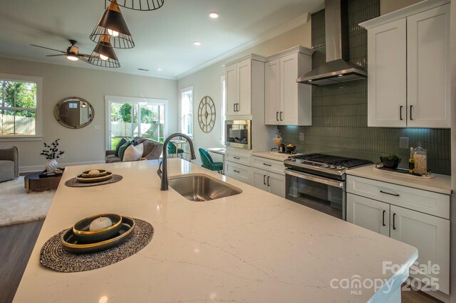 2630 Rose St, Charlotte, NC 28208 - kitchen featuring wall chimney exhaust hood, stainless steel gas range, open floor plan, and a sink