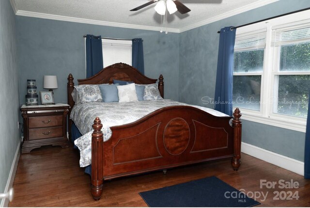 bedroom with dark wood-type flooring, crown molding, multiple windows, and ceiling fan