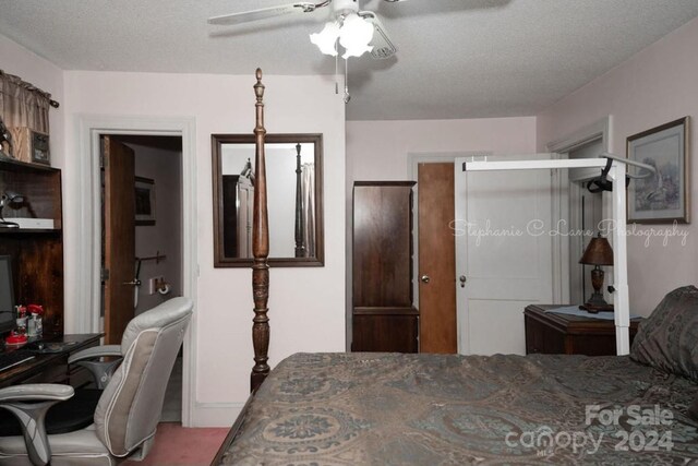 carpeted bedroom with a textured ceiling and ceiling fan