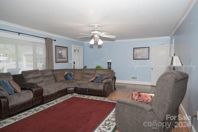 living room featuring ceiling fan, ornamental molding, and hardwood / wood-style floors