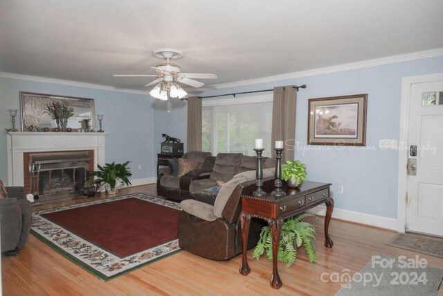 living room with ornamental molding, hardwood / wood-style flooring, and ceiling fan