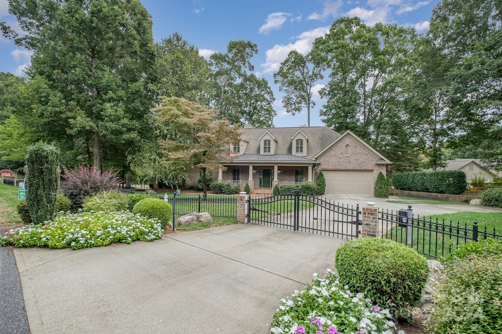 new england style home featuring a garage and a front lawn