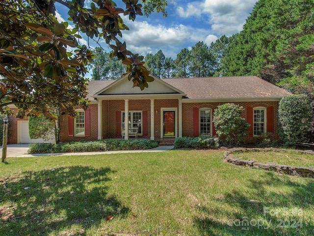 view of front of property with a garage and a front yard