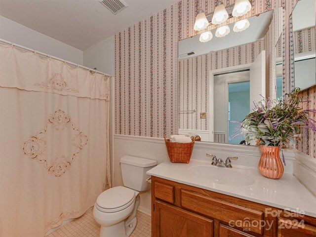 bathroom with tile patterned floors, vanity, and toilet