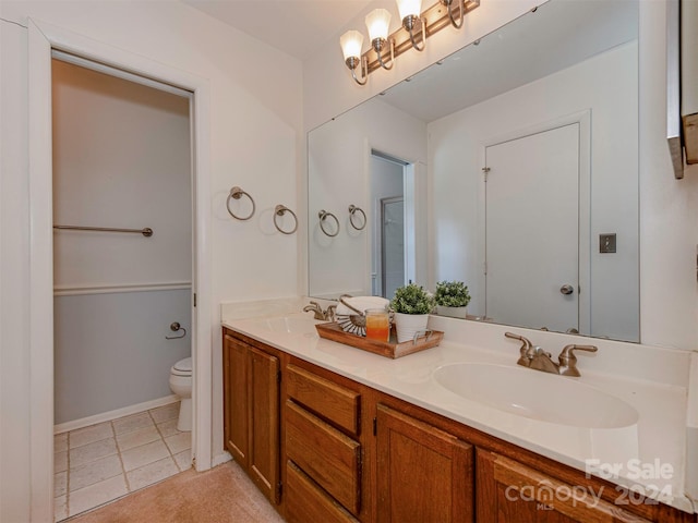 bathroom featuring tile patterned floors, vanity, and toilet