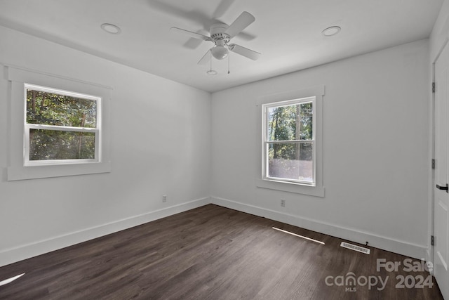 unfurnished room featuring recessed lighting, dark wood-style flooring, a ceiling fan, visible vents, and baseboards