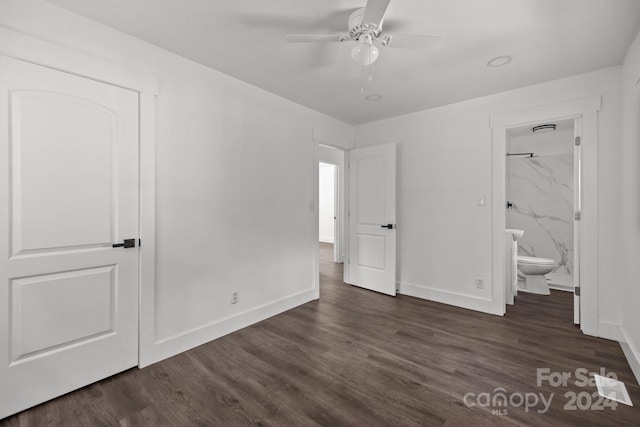 unfurnished bedroom with ensuite bath, baseboards, ceiling fan, and dark wood-type flooring