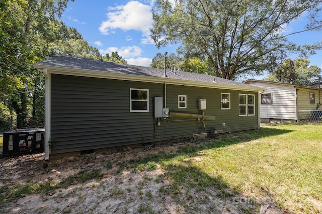 back of house with a lawn