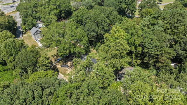 bird's eye view featuring a wooded view