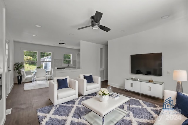 living room with baseboards, ceiling fan, wood finished floors, and recessed lighting