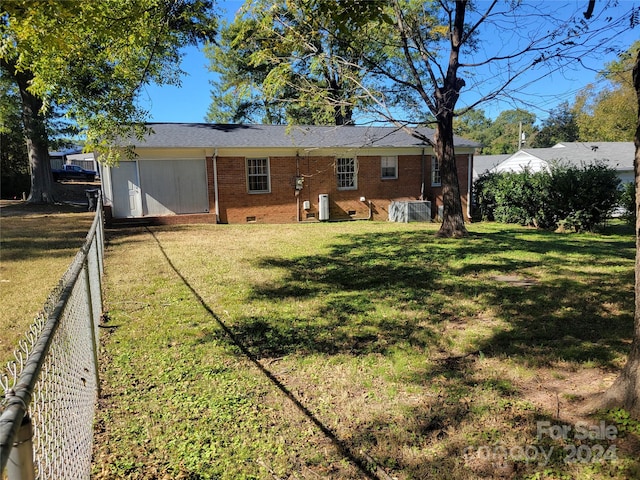 rear view of house featuring a lawn