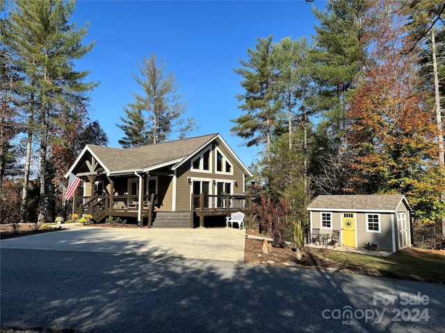 view of front of property with a storage unit and a deck