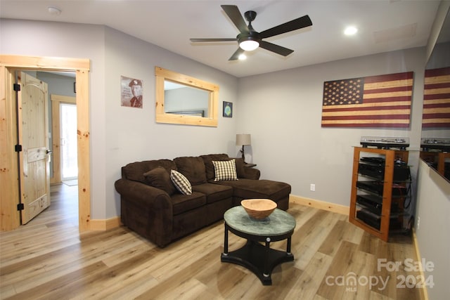 living room with light hardwood / wood-style floors and ceiling fan