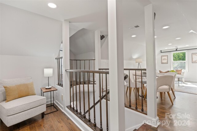 sitting room featuring hardwood / wood-style floors and vaulted ceiling