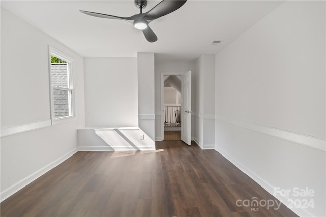 spare room with ceiling fan and dark hardwood / wood-style flooring