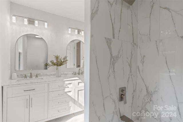 bathroom featuring vanity and tiled shower