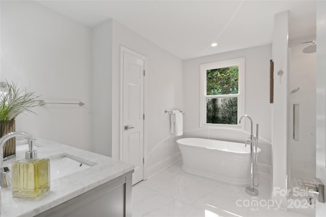 bathroom featuring vanity and shower with separate bathtub