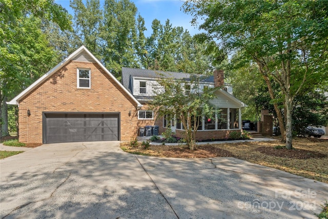 view of property featuring a sunroom and a garage