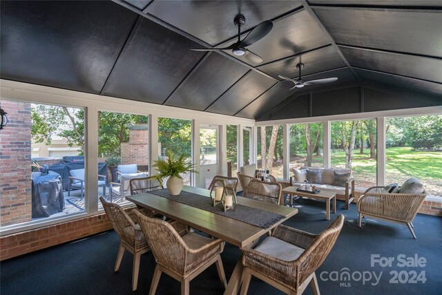 sunroom featuring a wealth of natural light, vaulted ceiling, and ceiling fan