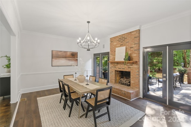 dining area featuring a brick fireplace, dark hardwood / wood-style floors, ornamental molding, and french doors