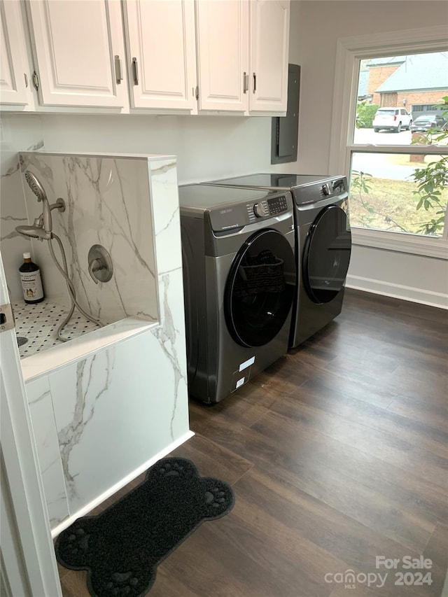 laundry area featuring cabinets, dark hardwood / wood-style flooring, washing machine and dryer, and electric panel