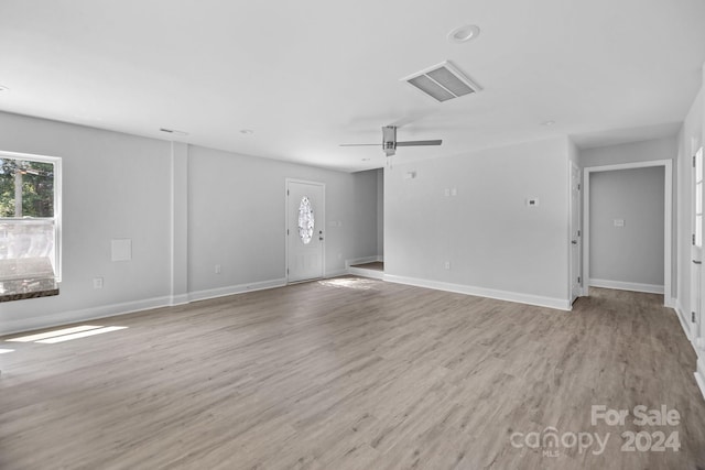 unfurnished living room with ceiling fan and light hardwood / wood-style floors