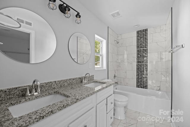 full bathroom featuring tiled shower / bath combo, vanity, and toilet