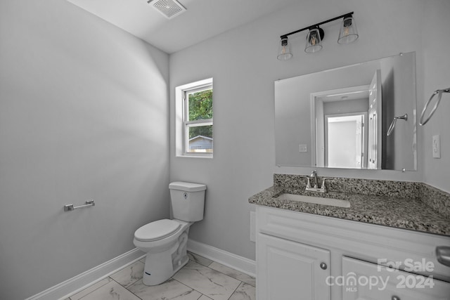 bathroom featuring toilet and vanity